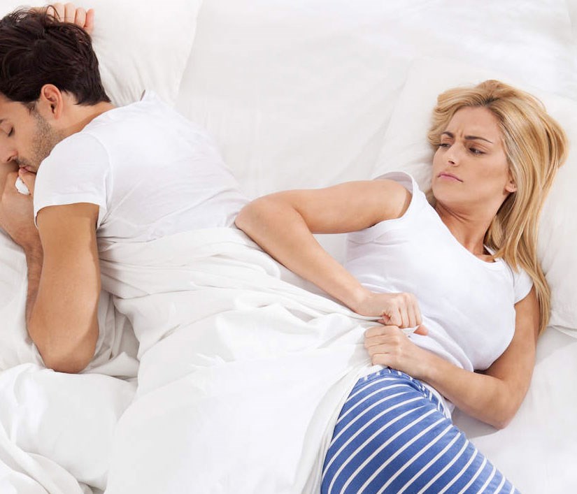 woman pulling on bed covers